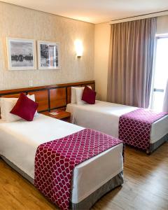 a hotel room with two beds and a window at Leques Brasil Hotel Escola in São Paulo +57 photos