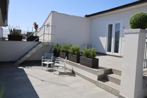 a patio with chairs and plants on a building at Royal View Apartment in Caserta