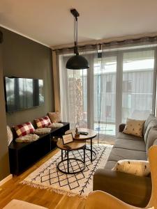 a living room with a couch and a table at Family Corner Bjelašnica in Bjelašnica