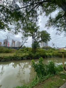 a river with trees and buildings in the background at Apartamento Gaya - Econômico e Confortável in Balneário Camboriú
