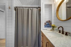 a bathroom with a shower curtain and a sink at Family Cottage, Sandy Beach & Paddleboards in Meredith +16 photos
