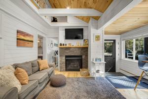 a living room with a couch and a fireplace at Family Cottage, Sandy Beach & Paddleboards in Meredith