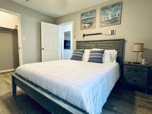 a bedroom with a large white bed with pillows at NEW Getaway by Gulfport Beach in Gulfport
