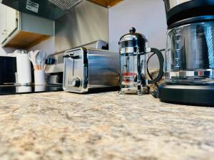 a kitchen counter with a coffee maker and a toaster at NEW Getaway by Gulfport Beach in Gulfport