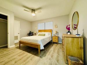 a bedroom with a bed and a ceiling fan at NEW Getaway by Gulfport Beach in Gulfport