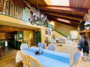 a dining room with a blue table and chairs at Sequoia Cabin by the River in Three Rivers