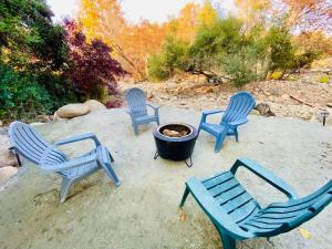 a group of blue chairs and a fire pit at Sequoia Cabin by the River in Three Rivers
