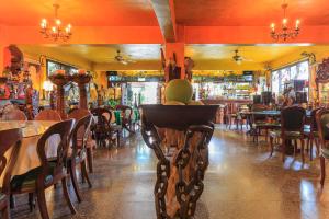 a restaurant with tables and chairs and a bar at Sun Moon Lake Full House Resort in Yuchi