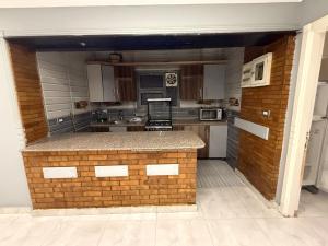 a kitchen with a brick counter in the middle at A Spacious, Stylish, and Perfectly Located in the heart of Cairo - Two bedroom Condo! in Cairo