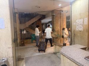 a group of people standing in a hallway at A Spacious, Stylish, and Perfectly Located in the heart of Cairo - Two bedroom Condo! in Cairo