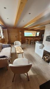 a living room with a couch and a table at Piernikowa Chata in Zawoja