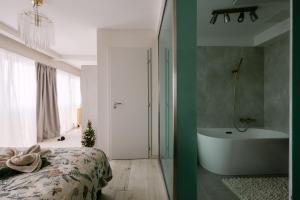 a bedroom with a bed and a bath tub at HelloWine Apartman in Eger +30 photos