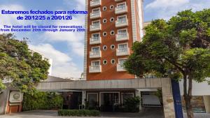 a building with a sign that reads the hotel will be closed for renovations at Regent Park Suite Hotel in Sao Paulo