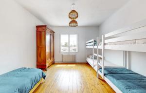 a bedroom with two bunk beds and a window at Maison Charentaise 12 à 14 personnes in Sémussac