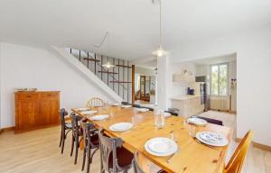 a dining room with a large wooden table and chairs at Maison Charentaise 12 à 14 personnes in Sémussac