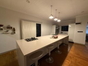 a kitchen with a large white island in a room at City Circle in Suva