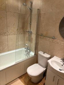 a bathroom with a toilet and a shower and a sink at Hatters Cottage Eldwick Bingley Yorkshire in Bingley