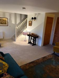 a living room with a couch and a table at Hatters Cottage Eldwick Bingley Yorkshire in Bingley +2 photos