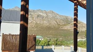 a view of a mountain through a window at Fijnbos - Something-Els in Rooiels