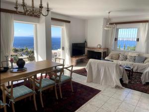 a living room with a table and a couch at Art Blue Residence - Panorama Maisonette in Aghia Marina