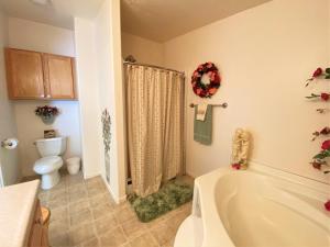 a bathroom with a bath tub and a toilet at Serendipity in Saint Ignace +30 photos