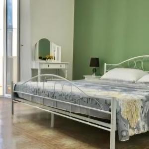 a bedroom with a large bed with a mirror at Equinox house in Tuglie