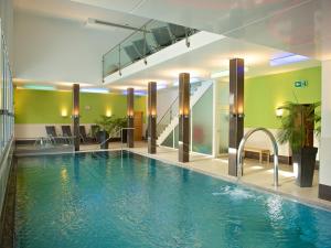 a large swimming pool in a hotel lobby at Schweizerhof Ferienwohnungen Lenzerheide Haus 6 in Lenzerheide