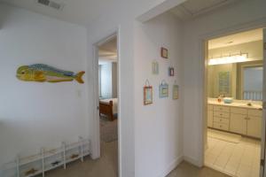a hallway with a bathroom with a fish on the wall at #3 B 18th Place in Tybee Island +16 photos