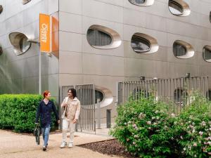 two women walking down a sidewalk in front of a building at Aparthotel Adagio Access Nancy Centre in Nancy +47 photos