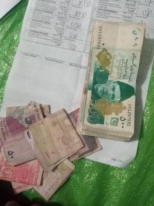 a pile of money sitting on top of a receipt at Hhxhd 