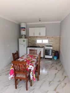 a kitchen with a table and chairs and a refrigerator at La finca in Fiambalá
