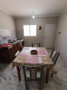 a kitchen with a table and a table and chairs at La finca in Fiambalá +3 photos