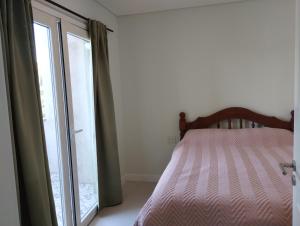 a bedroom with a bed next to a window at Apart Ezeiza F- hasta 5 personas con cochera in Tristán Suárez