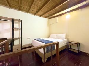 a small room with a bed and a balcony at Hotel Estadio 80 in Medellín