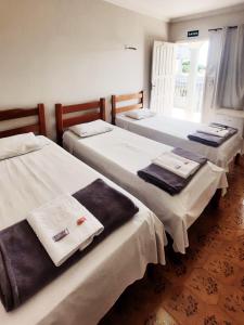 Un pat sau paturi într-o cameră la Ami Hotel