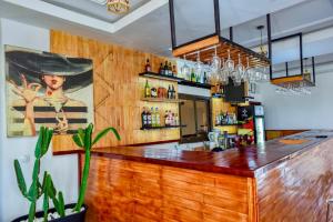 a bar with a wooden counter top in a restaurant at Milo & Aby Resort, Le Mar in Kribi