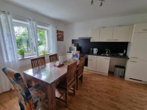 a kitchen with a wooden table and chairs in a kitchen at Workers Home Salzburg in Salzburg