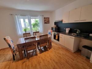 a kitchen with a table and some chairs and a table and a kitchen at Workers Home Salzburg in Salzburg