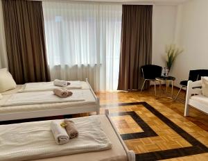 纽伦堡Pension Francesco的有两张床和一把椅子的酒店房间