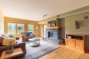 a living room with a couch and a fireplace at Spring Creek Serenity at Rundle Cliffs Lodge in Canmore