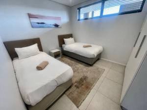 Postel nebo postele na pokoji v ubytování Ocean Dune T428