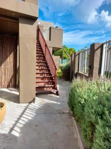 a stairway leading to a house with a fence at Fijnbos - Something-Els in Rooiels
