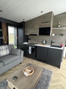 a living room with a couch and a table at The paddocks in Wisbech