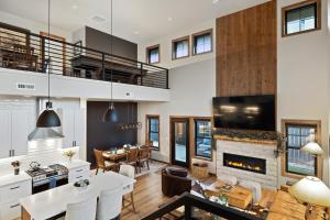 a living room with a fireplace and a dining room at Alpine Basecamp in Red Lodge