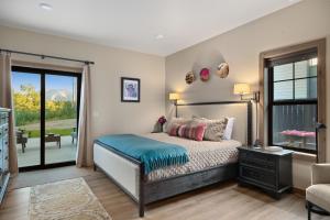 a bedroom with a bed with a blue blanket on it at Alpine Basecamp in Red Lodge +84 photos