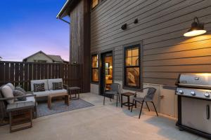 a patio with a couch and chairs and a grill at Alpine Basecamp in Red Lodge