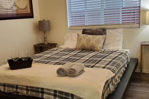 a bedroom with a bed with towels on it at Family Home with Hot Tub! 2 Mi to Dtwn Riverside in Rubidoux