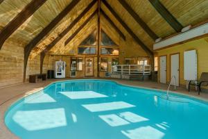 a swimming pool in a house with a wooden ceiling at The Bears Den in Red Lodge