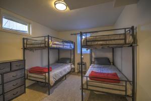 a bedroom with two bunk beds and a dresser at Daybreak Haven Red Lodge in Red Lodge