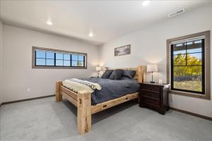 a bedroom with a wooden bed and a window at Beartooth Mountain Lodge - Private hot tub - $50 dollar with 3 night stay in Red Lodge +67 photos